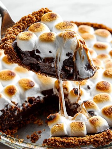 Homemade S'mores Brownie Pie with toasted marshmallows, gooey chocolate filling, and a graham cracker crust.