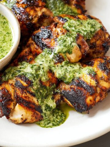Peruvian Chicken with Green Sauce topped with a vibrant green sauce, made with fresh herbs, garlic, and lime.